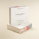 Laura Ashley perfume packaging on a beige background