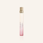 Laura Ashley Floral Fancy Perfume bottle with pink gradient and gold cap on a light beige background