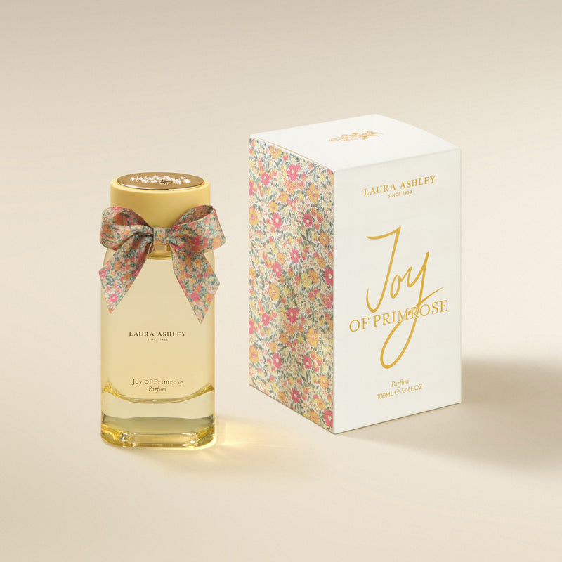 Laura Ashley Joy of Primrose perfume bottle and packaging on a beige background