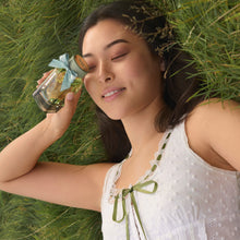 Model holding Serene Meadows Fragrance by Laura Ashley Parfum