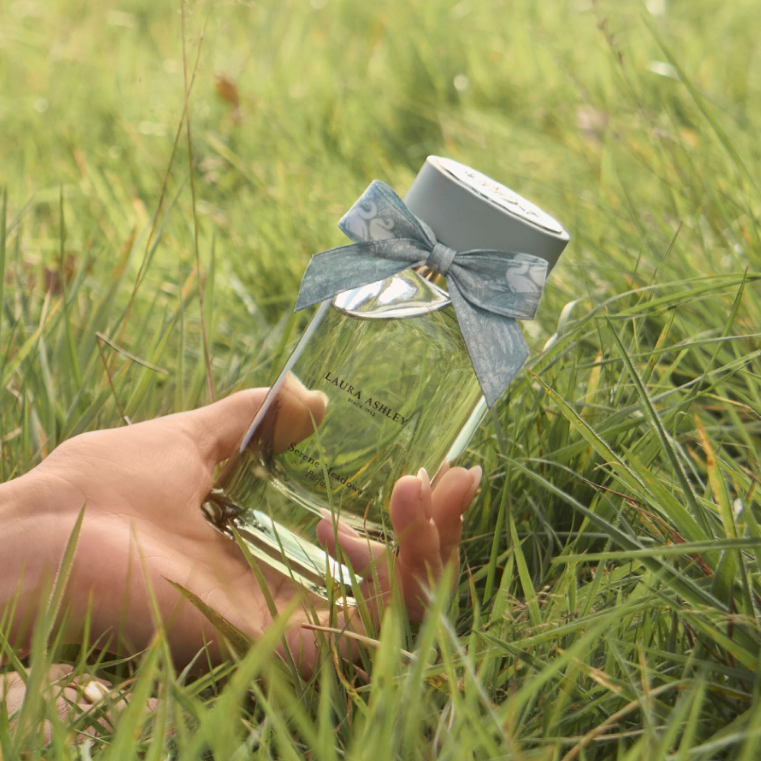 Serene Meadows Fragrance by Laura Ashley parfum bottle held in hand