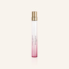 Laura Ashley Perfume bottle with pink gradient and gold cap on a light beige background