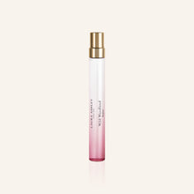 Laura Ashley Perfume bottle with pink gradient and gold cap on a light beige background